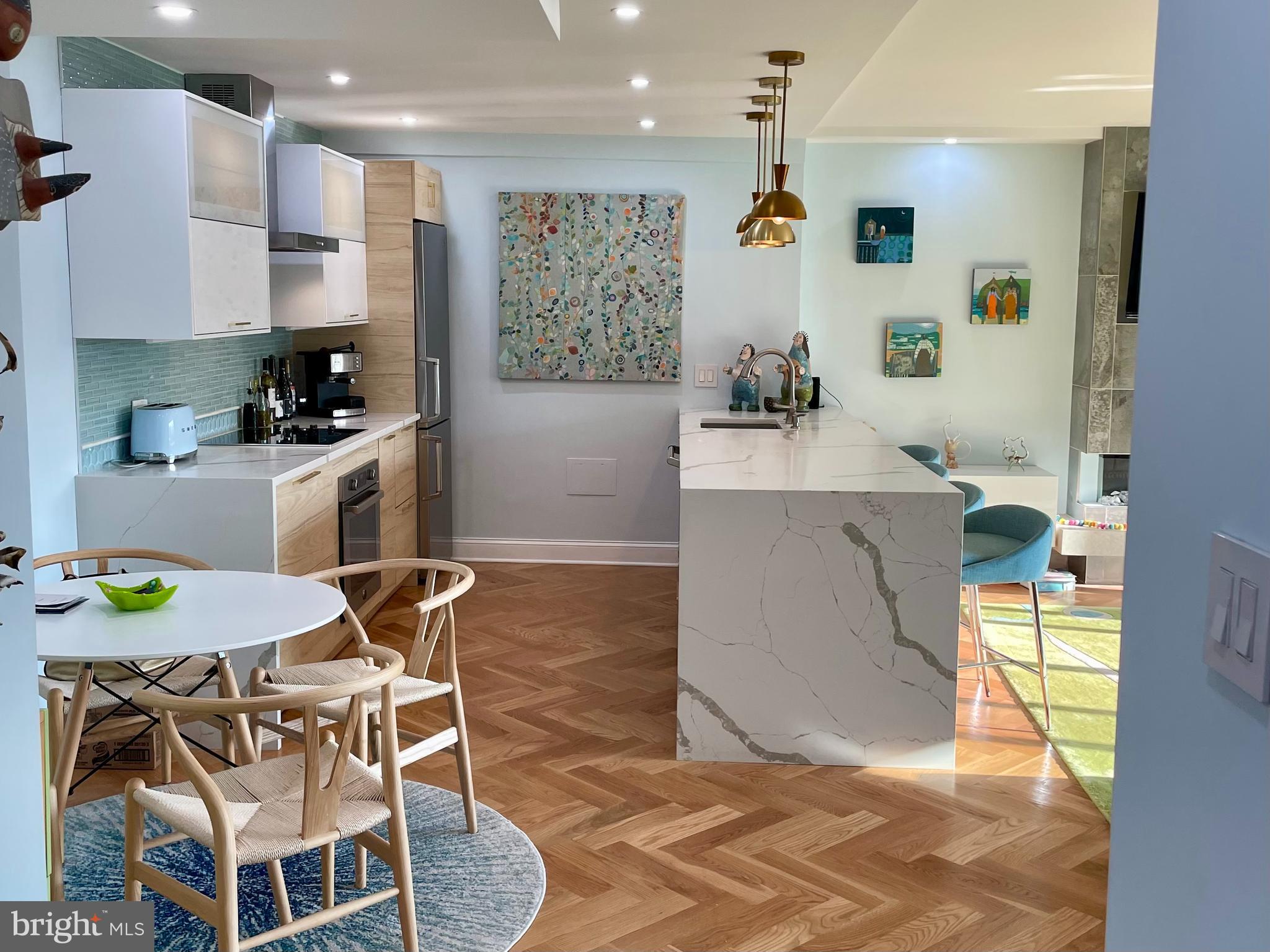 510 N Street Southwest, Unit N526 Washington, DC 20024 - Photo 4 of 9 a kitchen with stainless steel appliances kitchen island granite countertop a sink and a refrigerator