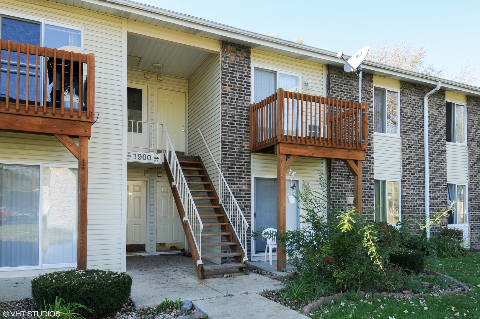 1900 Light Road, Unit 210 Oswego, IL 60543 - Photo 1 of 15 a front view of a house with a yard