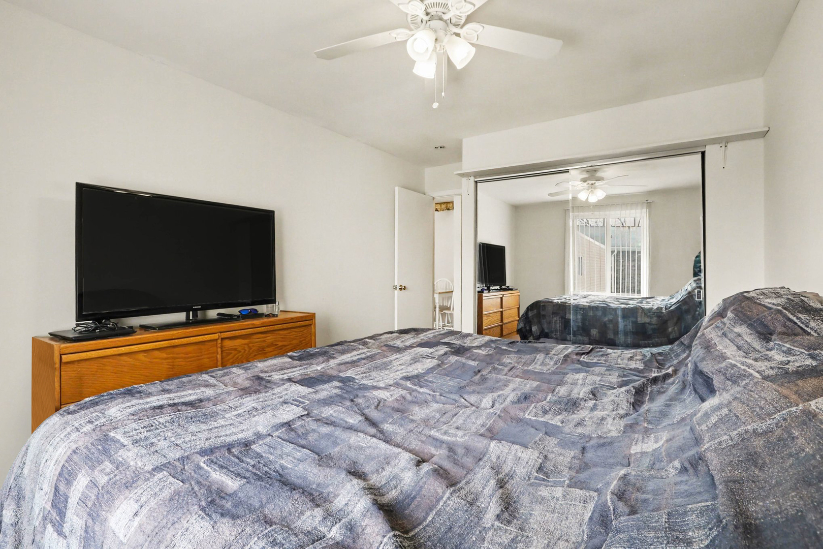 1900 Light Road, Unit 210 Oswego, IL 60543 - Photo 12 of 15 a bedroom with a bed and a flat screen tv