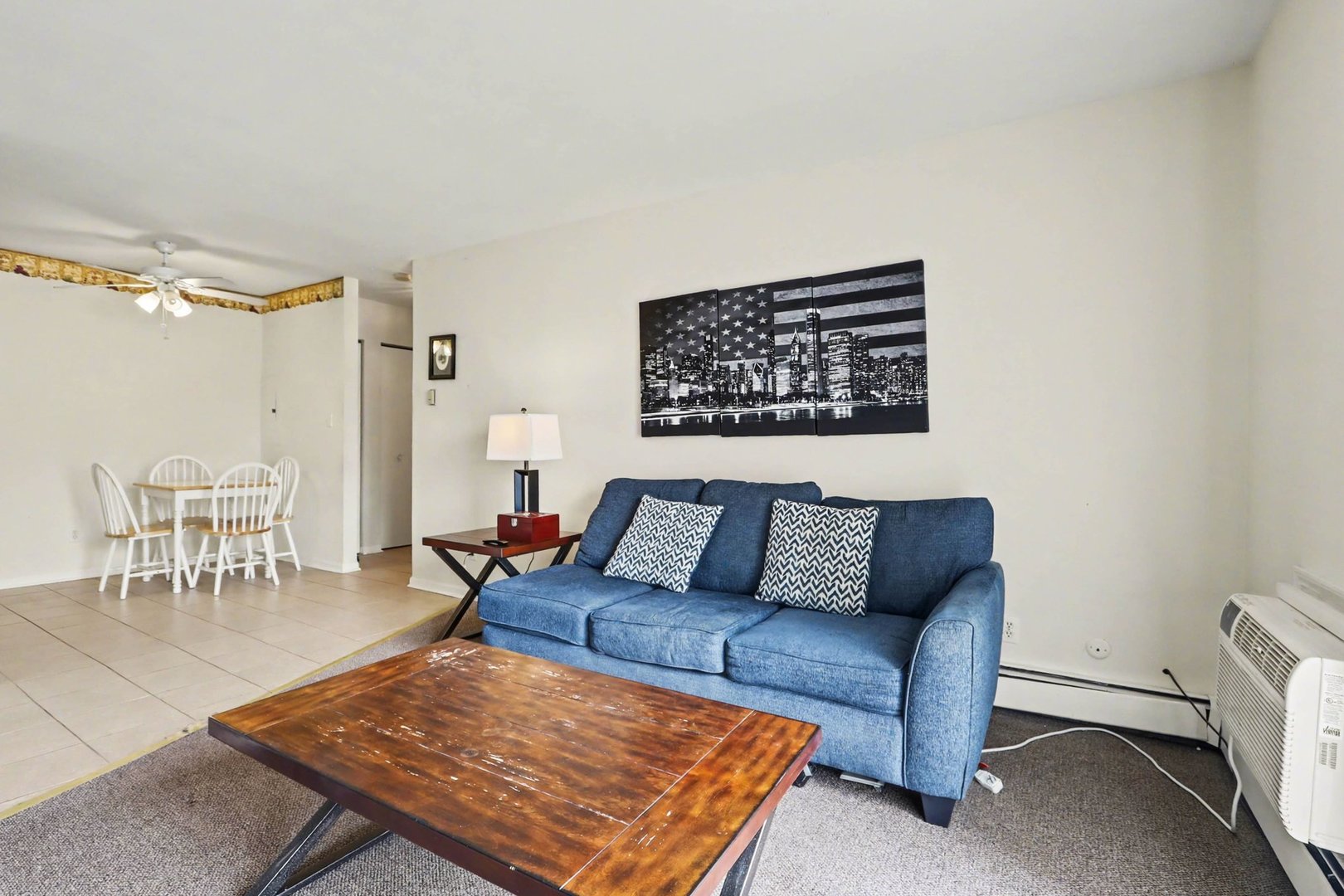 1900 Light Road, Unit 210 Oswego, IL 60543 - Photo 14 of 15 a living room with furniture rug and a table