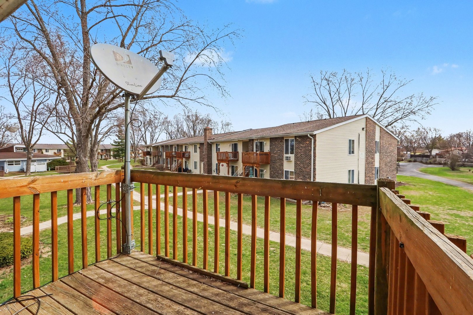 1900 Light Road, Unit 210 Oswego, IL 60543 - Photo 15 of 15 a view of a house with a wooden deck