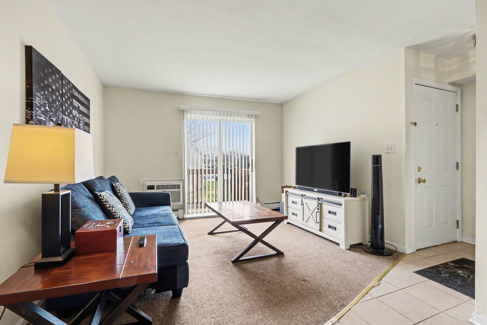 1900 Light Road, Unit 210 Oswego, IL 60543 - Photo 3 of 15 a living room with furniture and a flat screen tv
