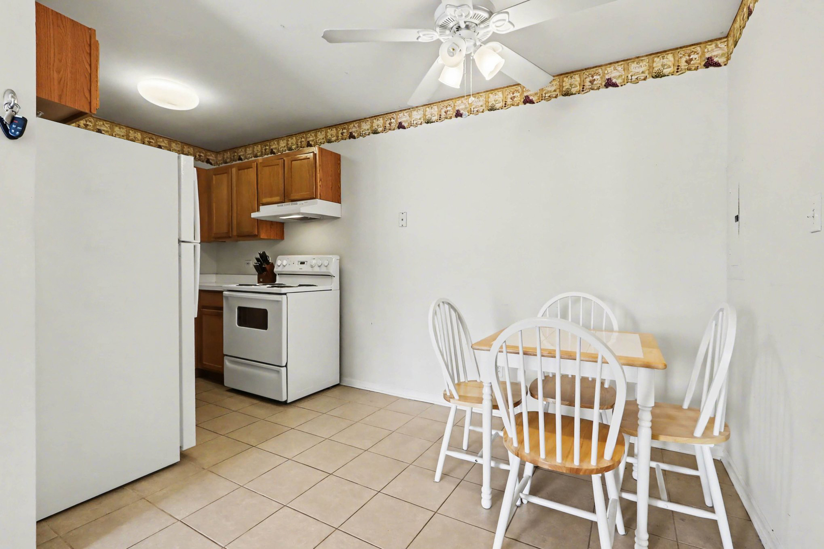 1900 Light Road, Unit 210 Oswego, IL 60543 - Photo 5 of 15 a view of a kitchen with dining table and chairs