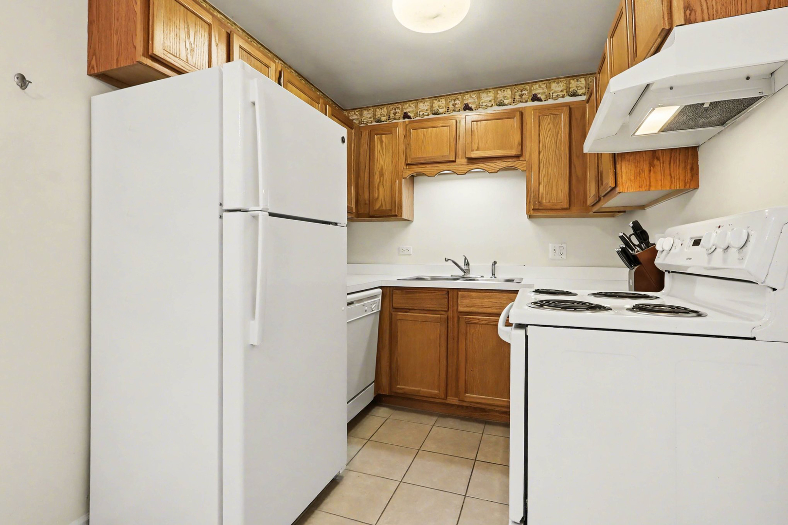 1900 Light Road, Unit 210 Oswego, IL 60543 - Photo 7 of 15 a kitchen with stainless steel appliances granite countertop a refrigerator and a sink