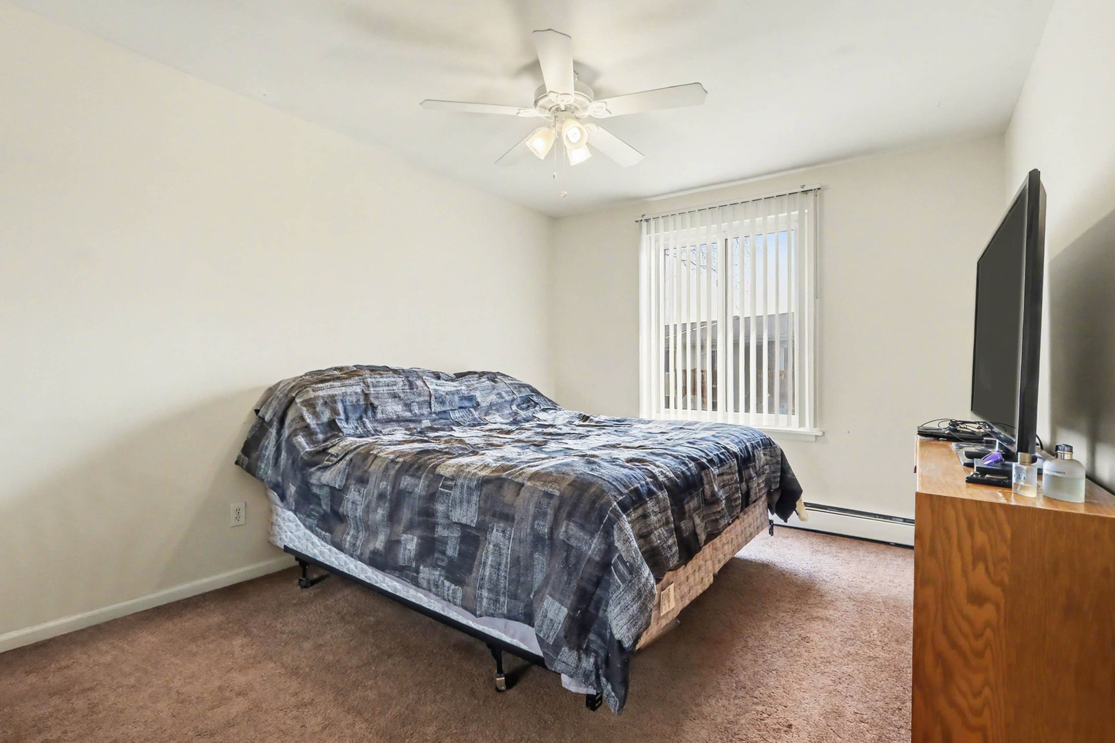 1900 Light Road, Unit 210 Oswego, IL 60543 - Photo 9 of 15 a bedroom with a bed and a flat screen tv