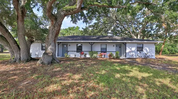 front view of a house with that has a tree