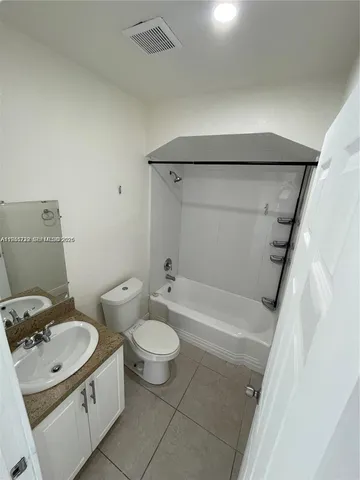 a bathroom with a sink mirror toilet and bathtub