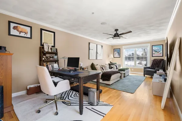 a living room with furniture a rug and a window