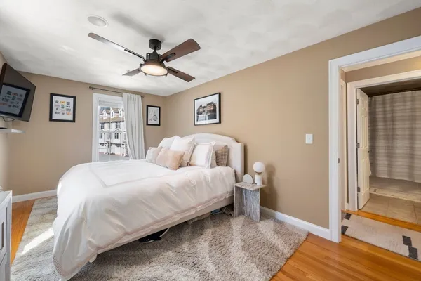 a bedroom with a bed and a ceiling fan