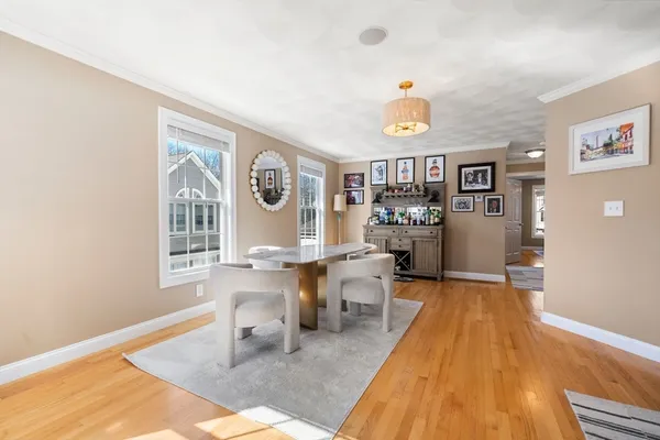a view of a dining room with furniture a chandelier and wooden floor