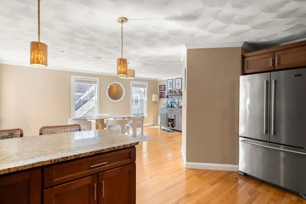 a kitchen with stainless steel appliances granite countertop a refrigerator a sink and a stove