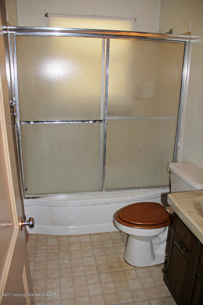 4303 South Lipscomb Street Amarillo, TX 79110 - Photo 16 of 35 a bathroom with a toilet a sink and a shower