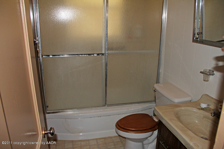 4303 South Lipscomb Street Amarillo, TX 79110 - Photo 17 of 35 a bathroom with a sink and a toilet