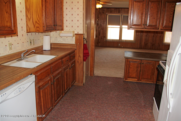 4303 South Lipscomb Street Amarillo, TX 79110 - Photo 10 of 35 a kitchen with stainless steel appliances granite countertop a sink stove and a refrigerator