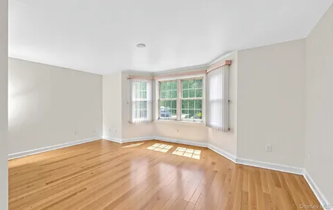 a dining room with furniture potted plants and wooden floor