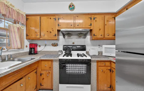 a kitchen with a sink stove and cabinets