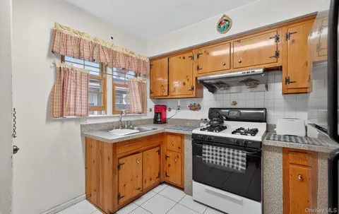 a kitchen with stainless steel appliances granite countertop a refrigerator a stove and a sink