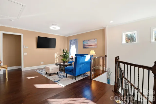 a living room with furniture wooden floor and a flat screen tv