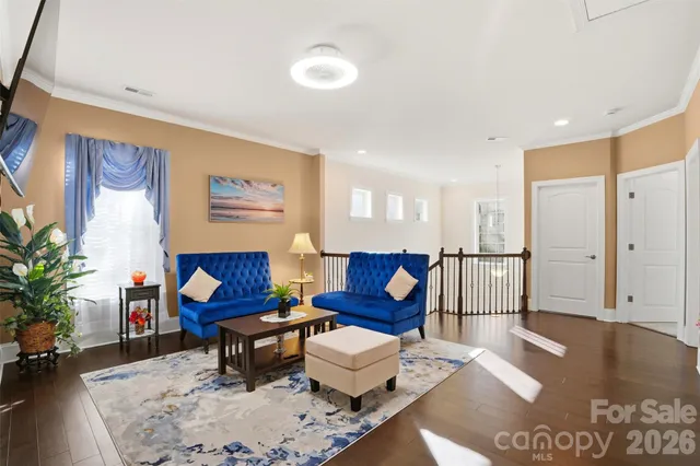 a living room with furniture and a painting on the wall