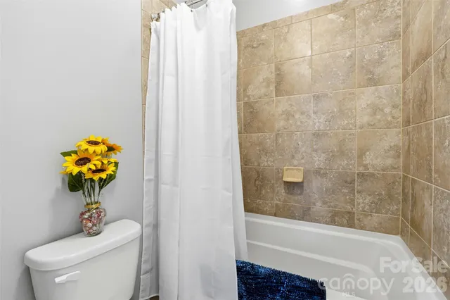 a bath tub sitting next to a white toilet and a sink