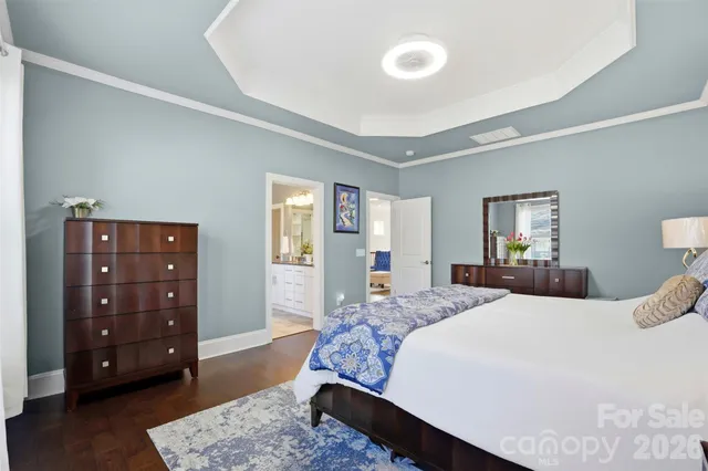 a bedroom with a bed a dresser and a couch