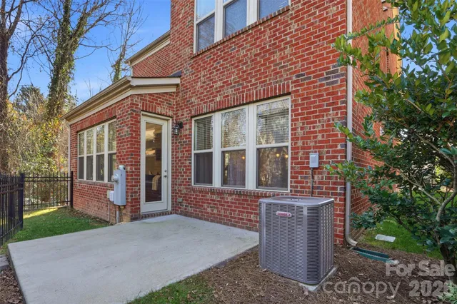a view of a brick house with a yard