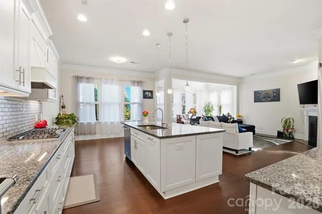 a kitchen with stainless steel appliances granite countertop a stove and cabinets