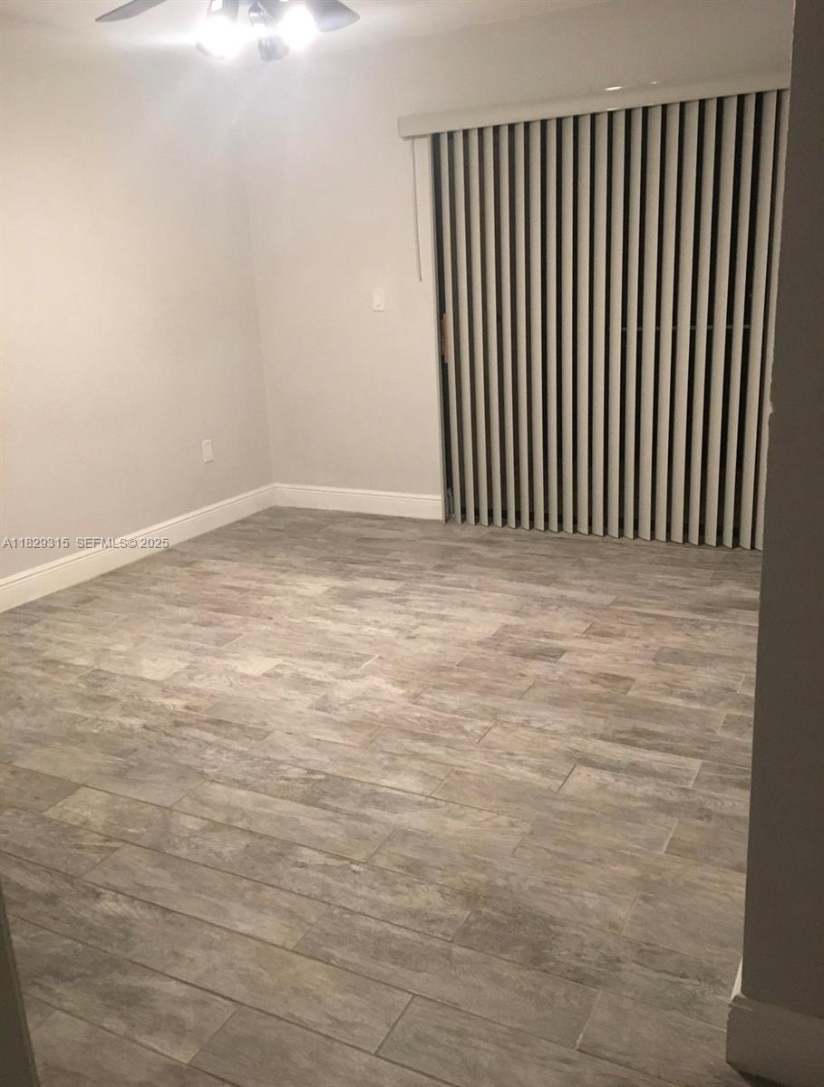 10670 Southwest 156th Place, Unit 309 Miami, FL 33196 - Photo 16 of 31 a view of a room with wooden floor