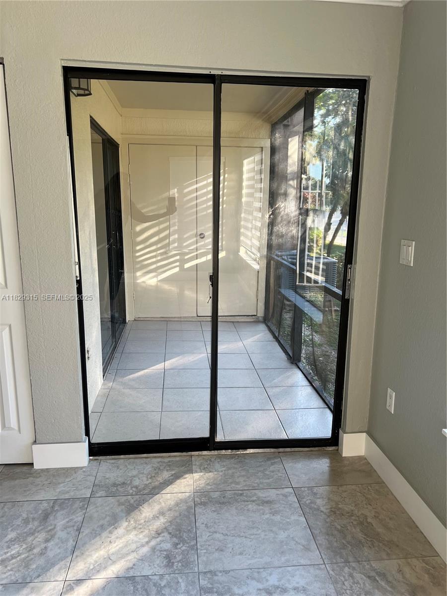10670 Southwest 156th Place, Unit 309 Miami, FL 33196 - Photo 18 of 31 a view of a hallway with wooden floor and a living room