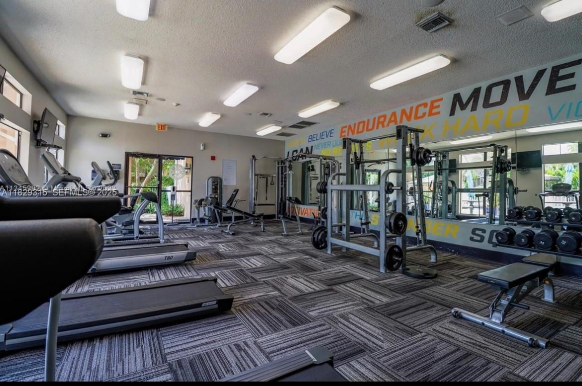10670 Southwest 156th Place, Unit 309 Miami, FL 33196 - Photo 22 of 31 a living room with lots of furniture and a rug