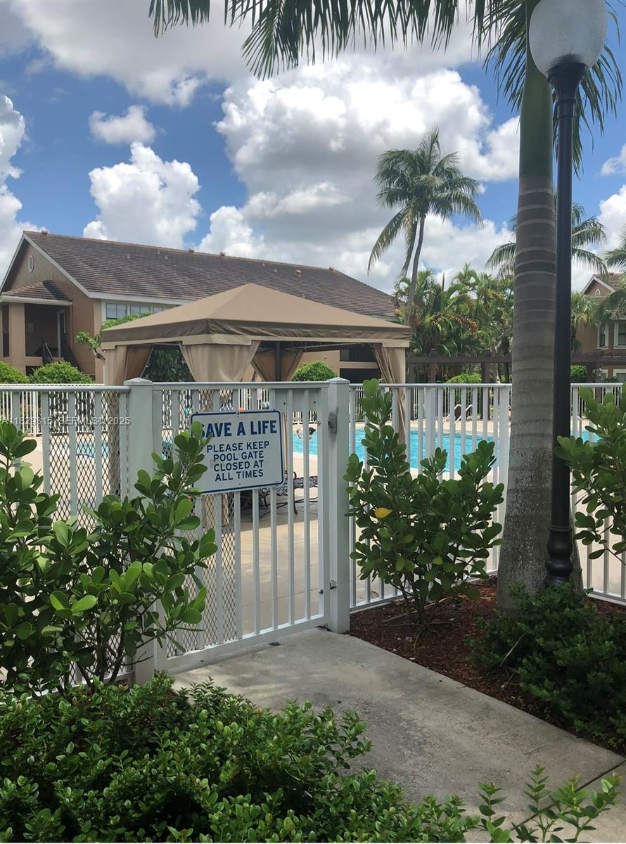 10670 Southwest 156th Place, Unit 309 Miami, FL 33196 - Photo 25 of 31 a front view of a house with garden