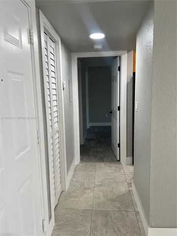 a kitchen with a refrigerator and a sink