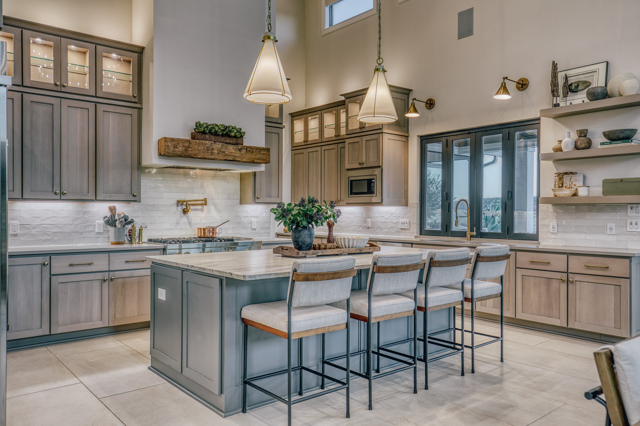 1034 Hilbun Road New Ulm, TX 78950 - Photo 21 of 49 Luxury meets functionality in this beautifully appointed kitchen showcasing professional-grade appliances, an oversized island, custom millwork, abundant storage, and a pass-through serving window to the outdoor entertaining space