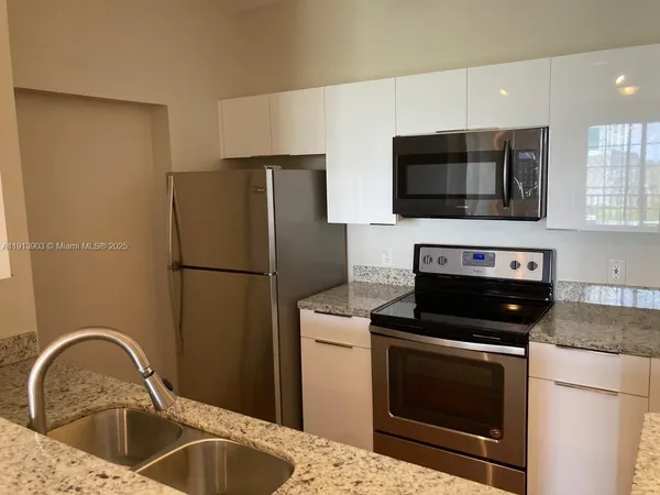 a kitchen with a refrigerator stove and microwave