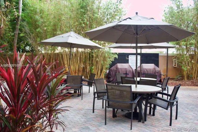 a patio with a patio table and chairs