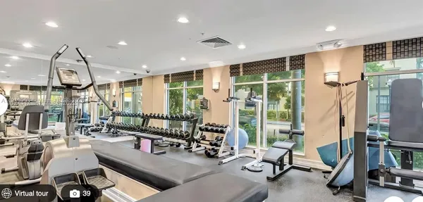a room with gym equipment and a large window