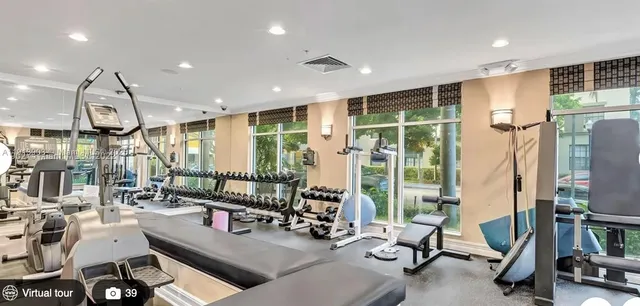 a room with gym equipment and a large window