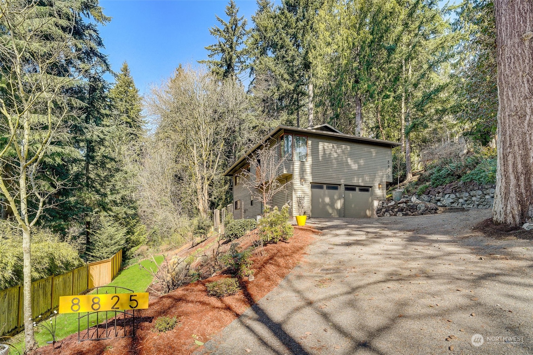 8825 Shell Place Edmonds, WA 98026 - Photo 36 of 40 a yellow house sitting in middle of forest
