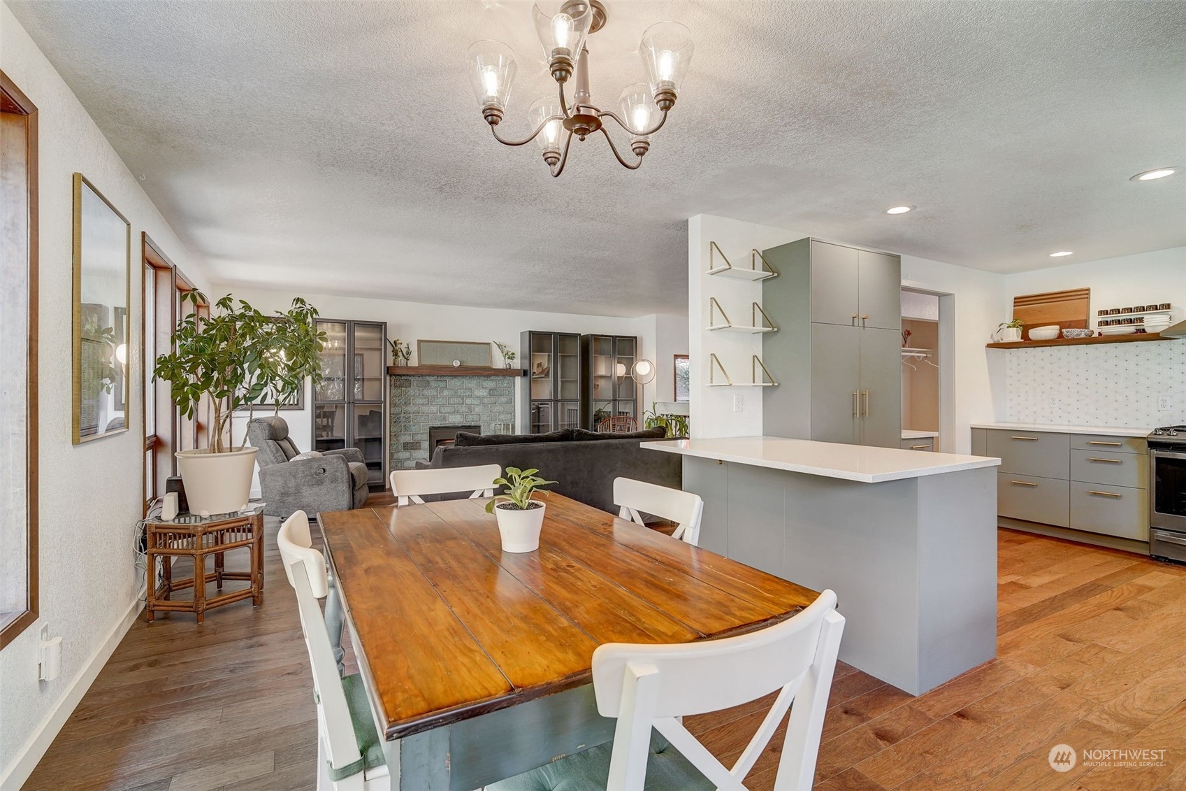 8825 Shell Place Edmonds, WA 98026 - Photo 7 of 40 a view of a dining room with furniture a chandelier and wooden floor