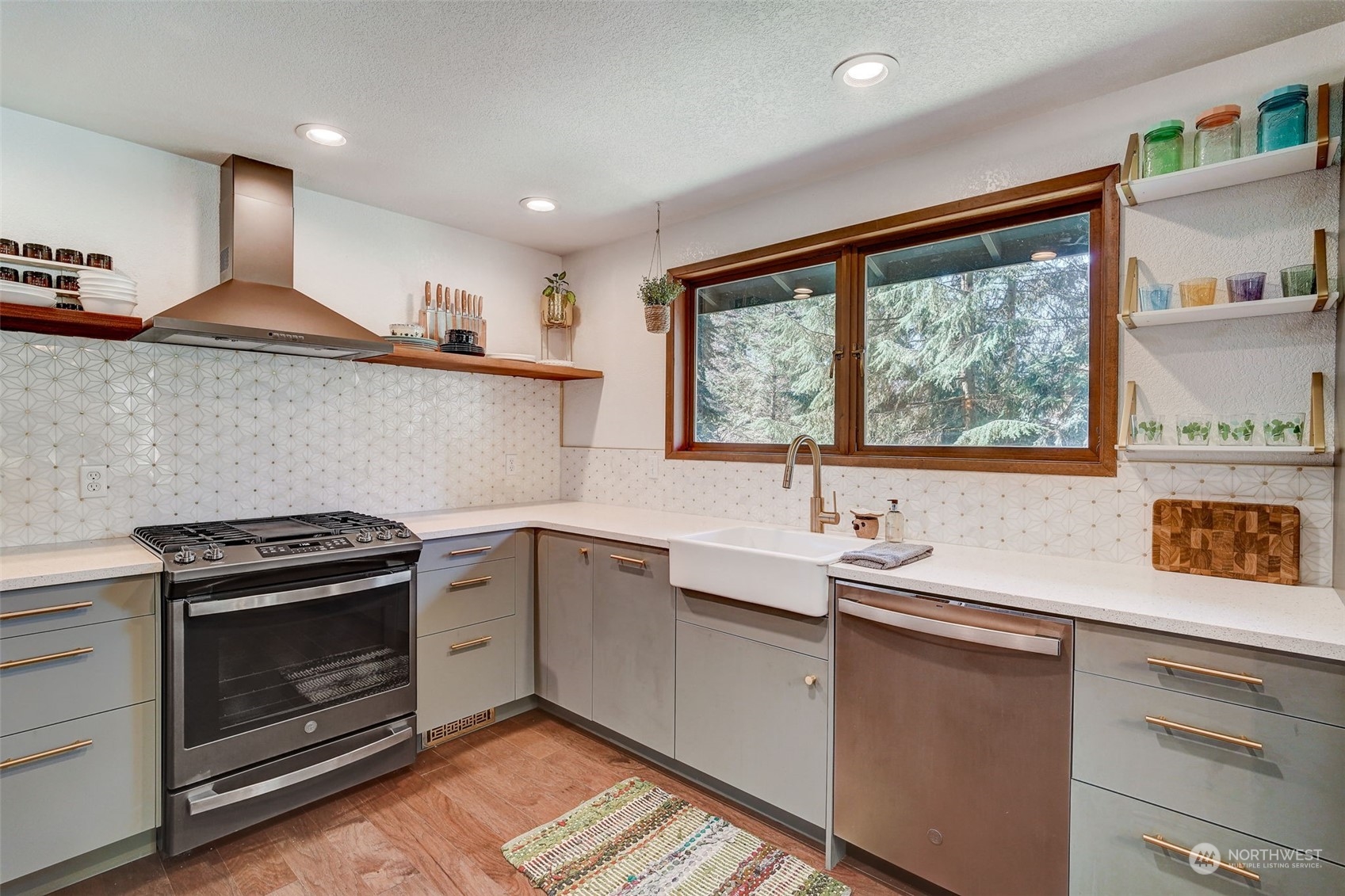 8825 Shell Place Edmonds, WA 98026 - Photo 10 of 40 a kitchen with stainless steel appliances a stove sink and cabinets
