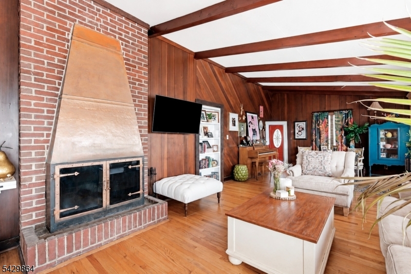 77 Lower North Shore Road Branchville, NJ 07826 - Photo 11 of 38 a living room with fireplace furniture and a flat screen tv