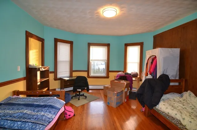 a living room with furniture window and wooden floor