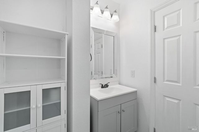 a bathroom with a sink vanity and a mirror