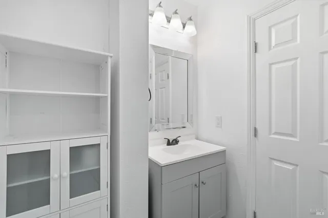 a bathroom with a sink vanity and a mirror