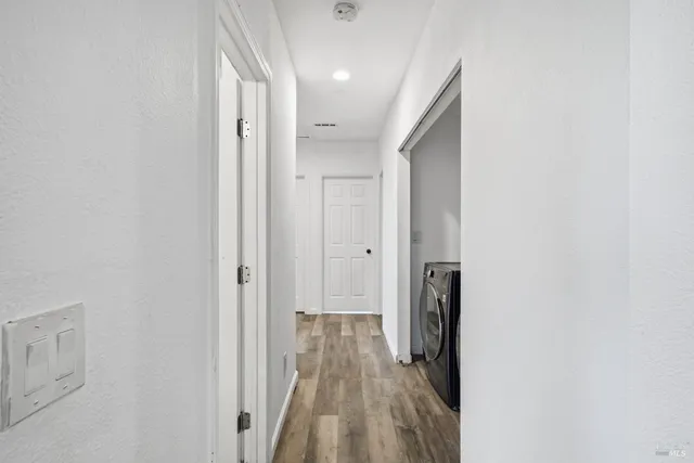 a view of hallway with wooden floor