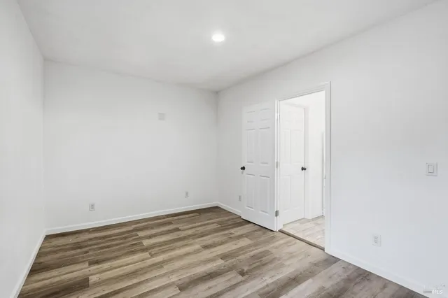 a view of a room with wooden floor