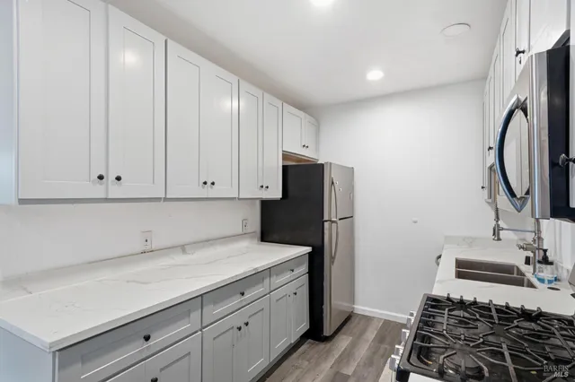a kitchen with a sink stove and refrigerator