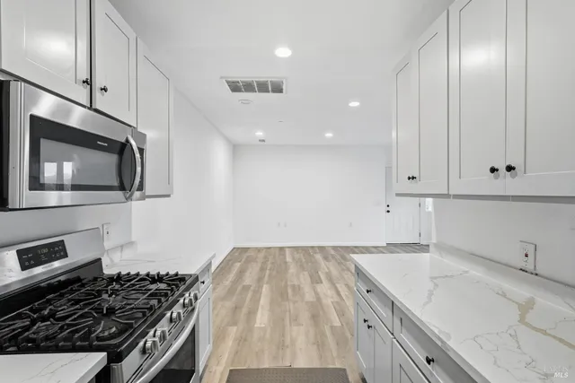 a kitchen with granite countertop a stove and a sink