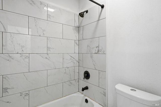 a bathroom with a bathtub and toilet