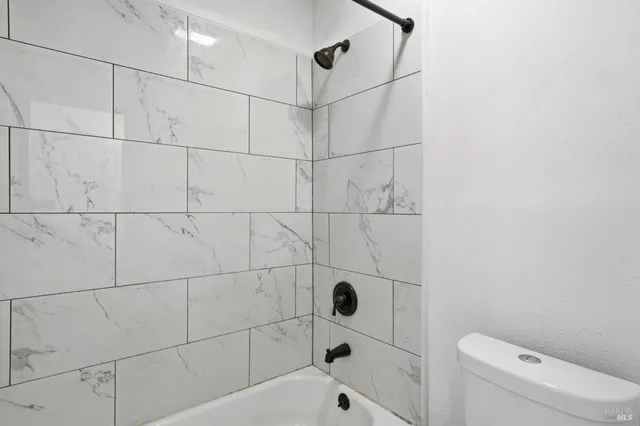 a bathroom with a bathtub and toilet